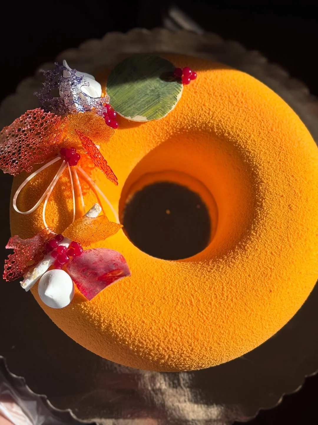 L'Or — blood-orange crémeux with velvet spray, cassis pearls and pulled-sugar lace